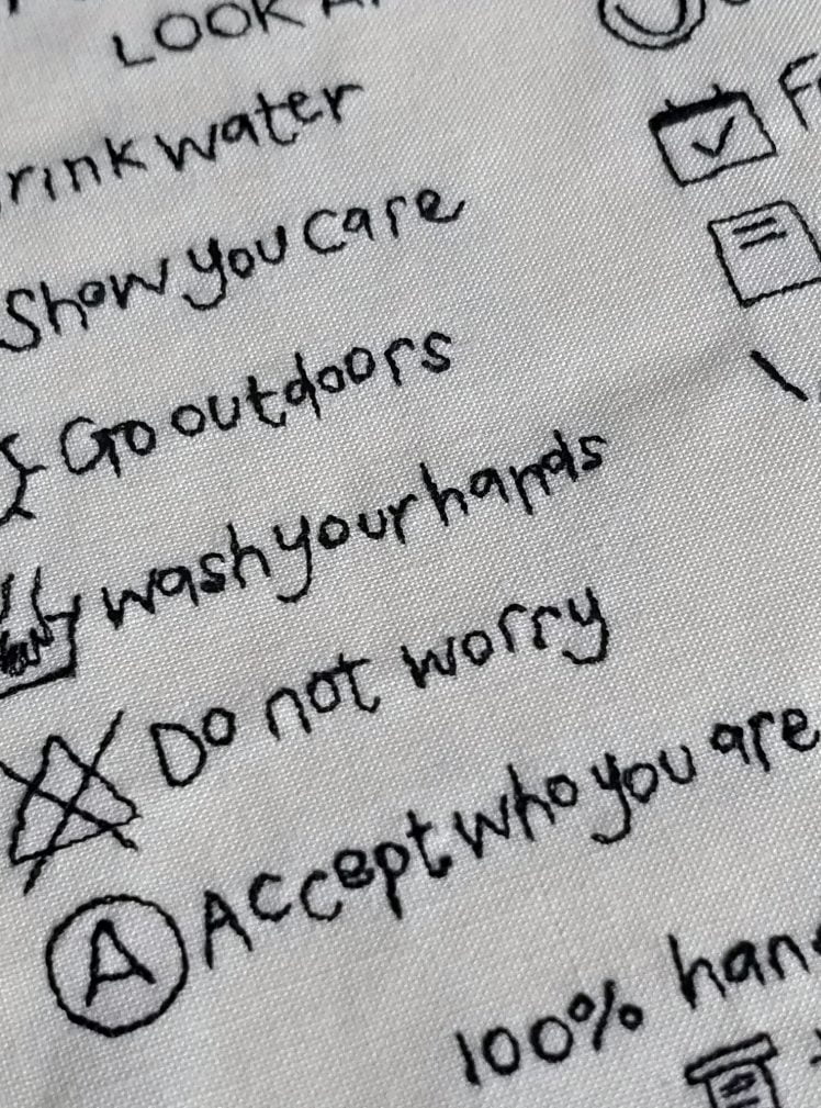 Embroidered care instructions artwork