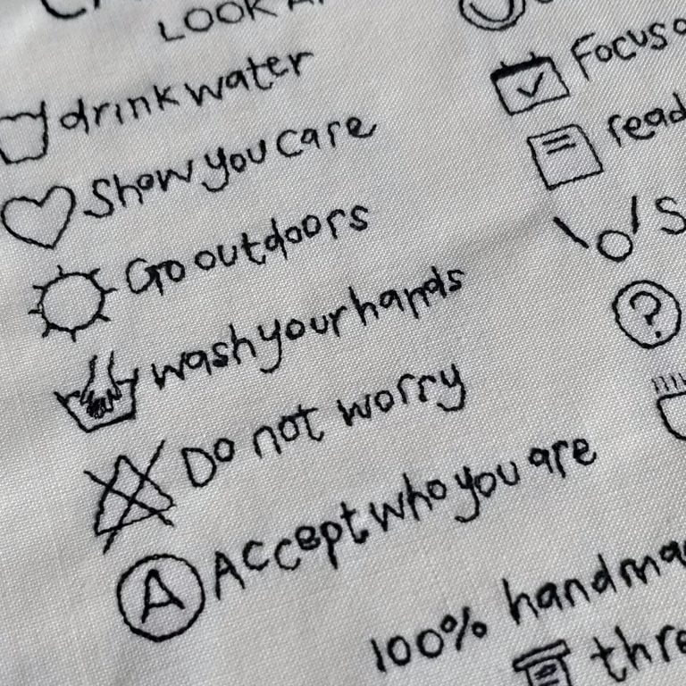 Embroidered care instructions artwork